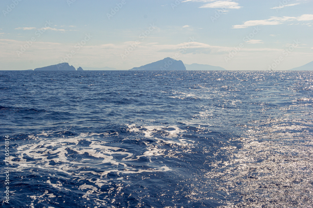 Sea view from the sailing boat of a volcanic island in Aeolian archipelago in the Tyrrhenian Sea. Salina is one of the Aeolian islands in Italy