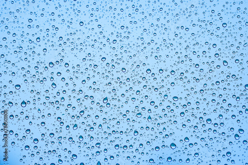 Raindrops on Window. Water drop texture on blue background. Close up water drop texture on blue background
