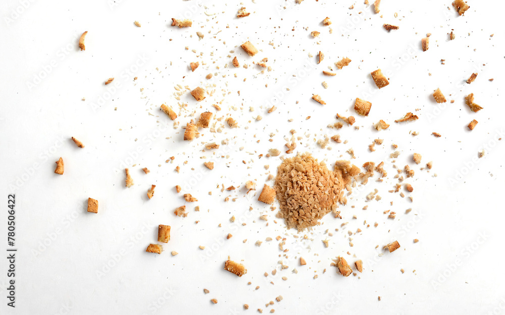 scattered crumbs of roasted white bread on a white background closeup scattered crumbs of roasted white bread on a white background closeup