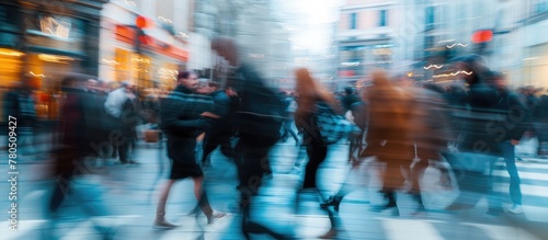 Blurred motion of rushing individuals on the street.