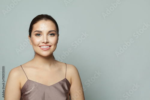 Lovely young woman with fresh silky skin posing on white background. Fashion beauty studio portrait