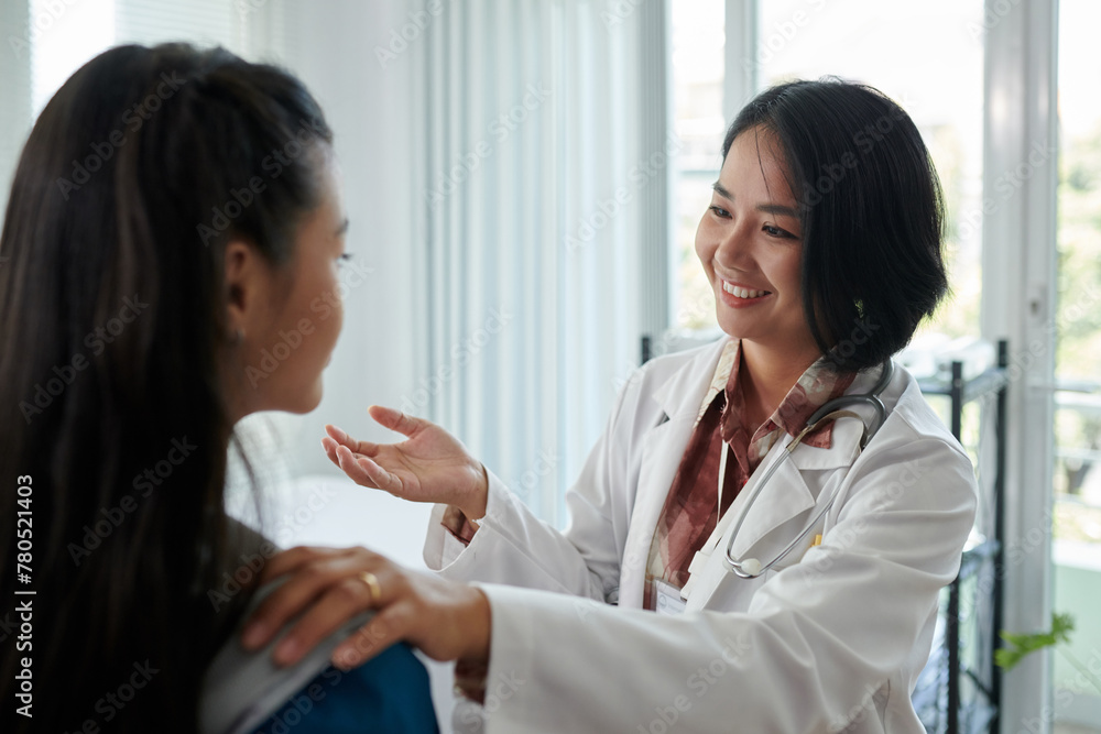 Smiling pediatrician examining teenage girl Smiling pediatrician examining teenage girl