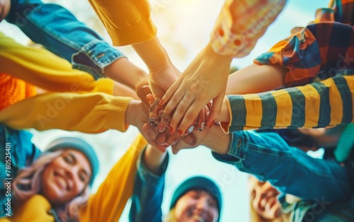 The concept of working together, friends and colleagues joining hands together in the air, close-up