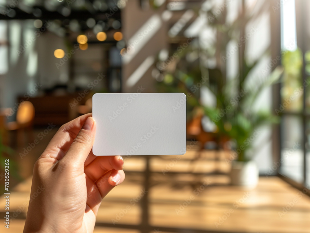 a hand hold a white name card, shot from close up angle a hand hold a white name card, shot from close up angle