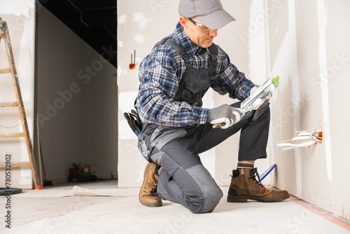 Contractor Worker in His 40s Patching Drywall