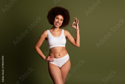 No retouch photo of shiny pretty lady underwear showing okey enjoying self acceptance empty space isolated green color background