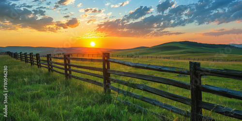 Golden Sunset Over Serene Countryside Landscape with Rustic Fence