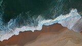 Powerful ocean wave over sand beach. Aerial top down view of sea surf on the beach