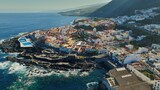 Aerial view of old town of Garachico on island of Tenerife, Canary. Flying over Garachico city center with colored houses. Ocean shore and lava pools. Popular tourist destination, Canary Islands