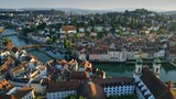 Aerial morning view of Lucerne old town and Reuss river. View of Jesuitenkirche Hl. Franz Xaver church and old houses in Luzern city center, Switzerland, shot at sunrise