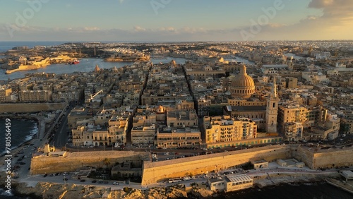 Flying over Valletta city, Malta. Aerial shot of Valletta old town in Malta during sunset