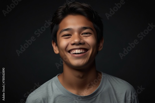 young filipino teenage boy on plain bright black background laughing hysterically looking at camera background banner template ad marketing concept from Generative AI