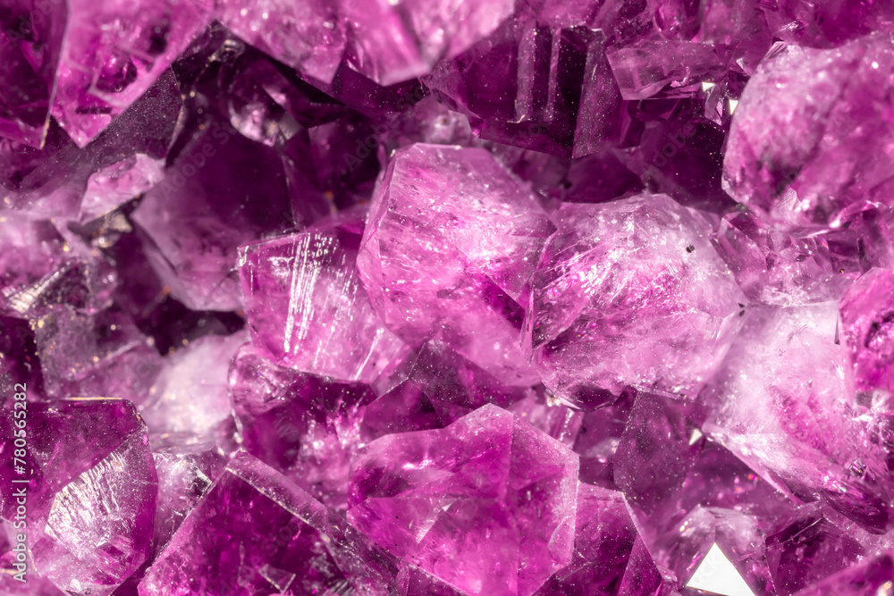 Amethyst pink crystals. Gems. Mineral crystals in the natural environment. Texture of precious and semiprecious stones. Seamless background with copy space colored shiny surface of precious stones. Amethyst pink crystals. Gems. Mineral crystals in the natural environment. Texture of precious and semiprecious stones. Seamless background with copy space colored shiny surface of precious stones.