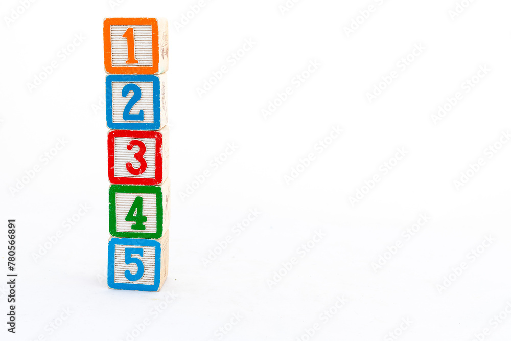 Educational toy blocks tower with one, two, three, four and five numbers isolated on white background with copy space Educational toy blocks tower with one, two, three, four and five numbers isolated on white background with copy space