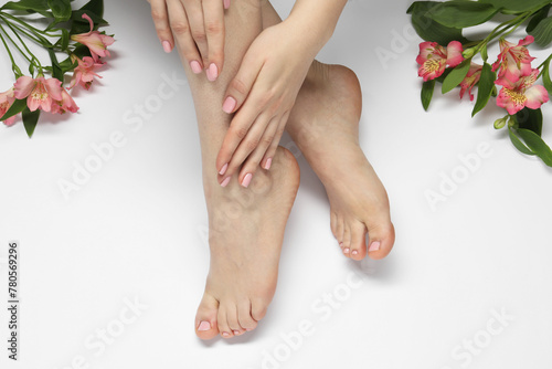 Closeup of woman with neat toenails after pedicure procedure on light background  top view