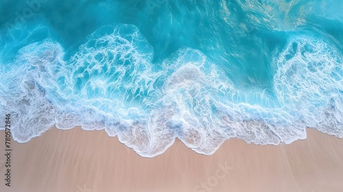 Aerial drone footage of sea ocean waves reaching shore. Beach clear turquoise top view