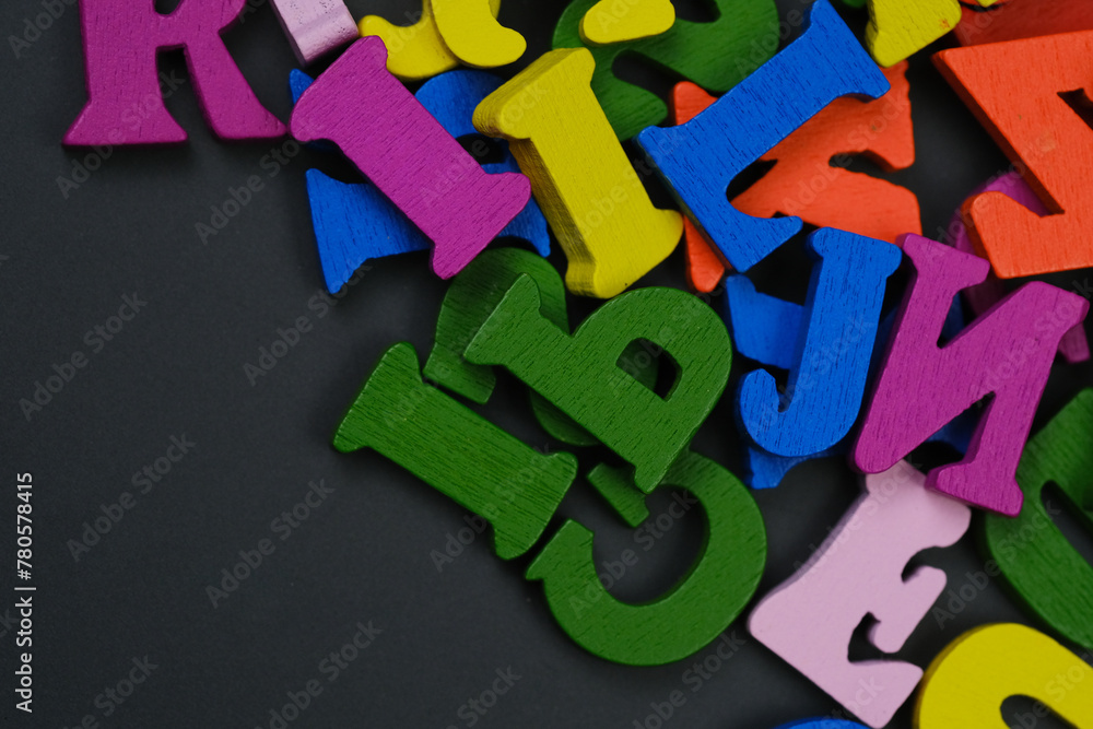Fototapeta premium Colorful Wooden Letters Piled on Table, School Concept, Education Banner 