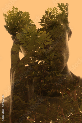 An artistic double exposure portrait silhouette of a man on a yellow background