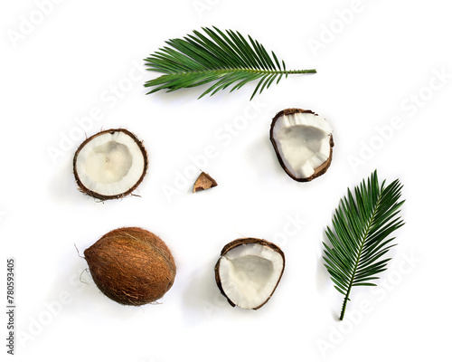 Coconut ( Cocos nucifera ) with halfs and palm leaves on a white background with space for text. Top view, flat lay © Anastasiia Malinich