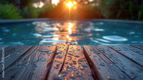 Empty brown wet wood surface in front of a blurred swimming pool. A tropical summer background used for product display. photo