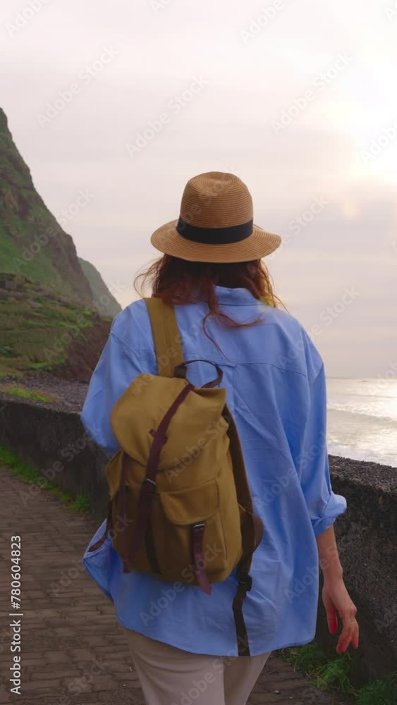 Vertical video. Camera follows woman hiker with backpack. Traveler hiker, enjoys nature and life. Traveling in the mountains, adventure in trip. Woman walking on mountain trail in Madeira Vertical video. Camera follows woman hiker with backpack. Traveler hiker, enjoys nature and life. Traveling in the mountains, adventure in trip. Woman walking on mountain trail in Madeira
