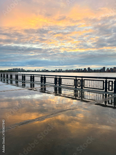 Sunset on the embankment after the rain. Reflection of the sky in the wet pavement, Kazan, Russia