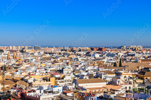 Aerial panoramic view of the old city rooftops from the Giralda Tower in Seville, Andalusia, Spain © olyasolodenko