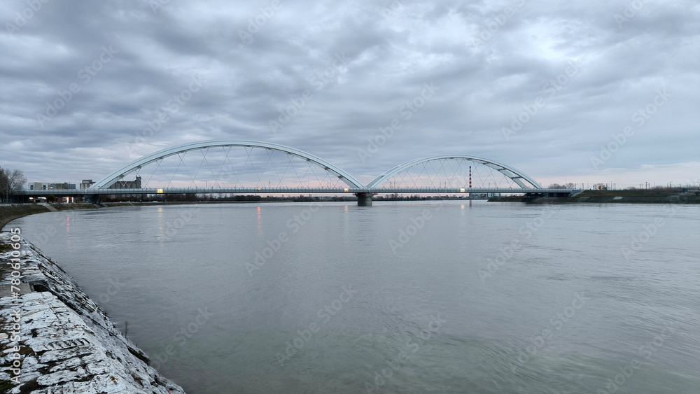 Naklejka premium panoramic view of the bridge over Danube river in Novi sad, reflected in the water surface