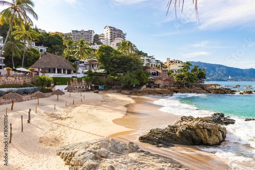Aerial view of a tropical resort beach with palm trees and turquoise water in Puerto Vallarta