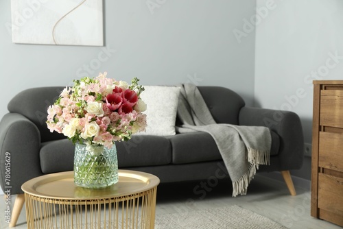 Beautiful bouquet of fresh flowers on coffee table in room, space for text © New Africa