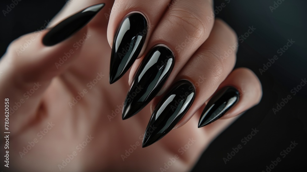 Close-up of black glossy stiletto nails. Close-up of black glossy stiletto nails.