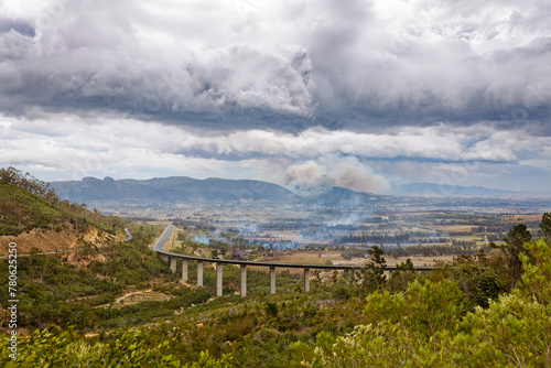 A view over Paarl, Western Cape, South Africa during extreme winds, and fires burning in many places in the valley. The distant mountains are haze because of smoke and dust blowing over the valley.