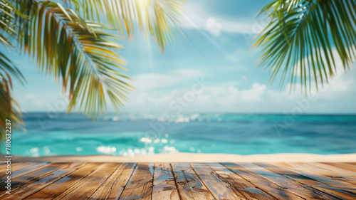 Abstract blurred background of wooden table top with palm leaves and blue sea in the summer photo