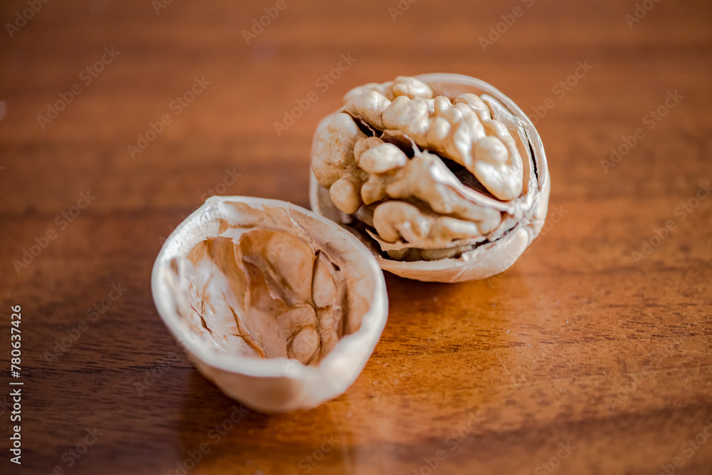Walnuts that have been smashed open for consumption, with walnut skins on the table Walnuts that have been smashed open for consumption, with walnut skins on the table