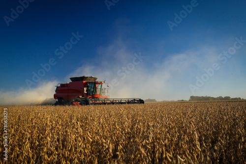 A combine harvester at work harvesting a soybean field.