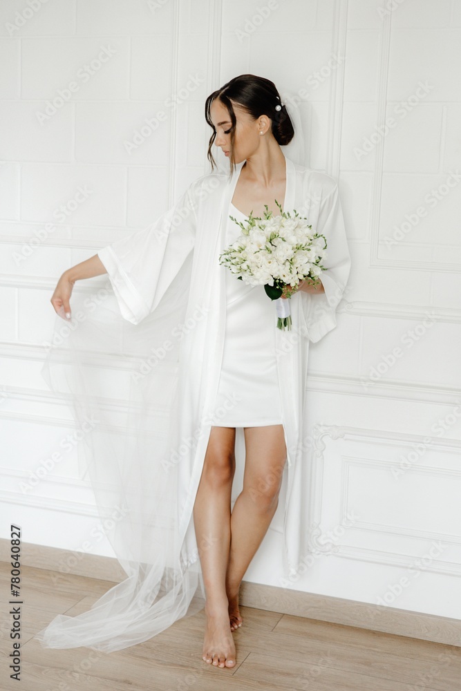 Dreamy Bride in White Getting Ready for Her Special Day in a White Room Dreamy Bride in White Getting Ready for Her Special Day in a White Room