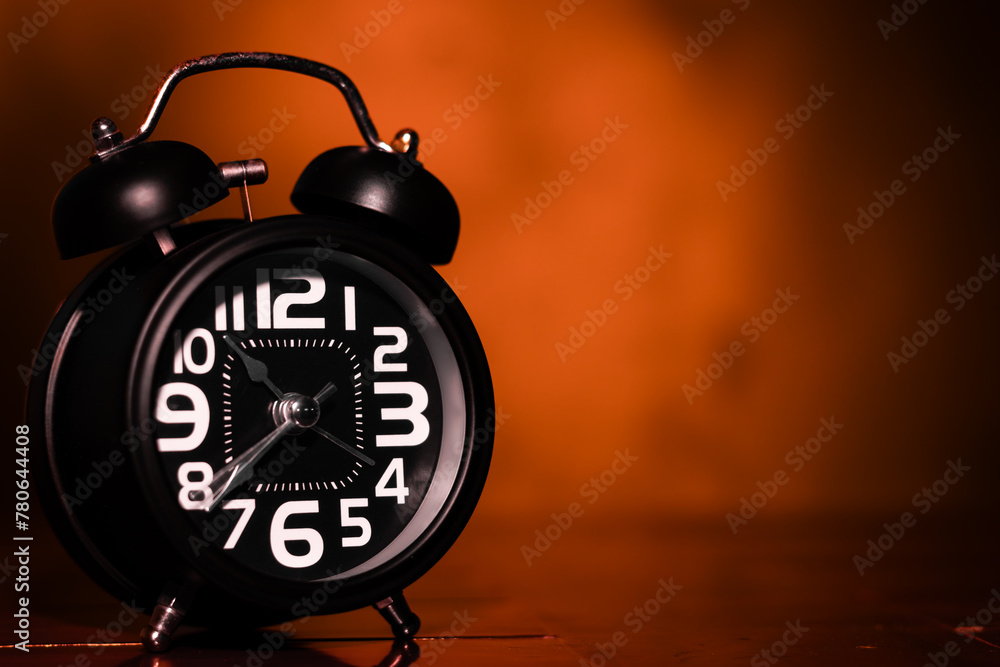 Black retro alarm clock on wooden table Black retro alarm clock on wooden table