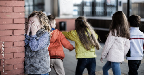 Bild auf Leinwand Children playing hide and seek in the schoolyard