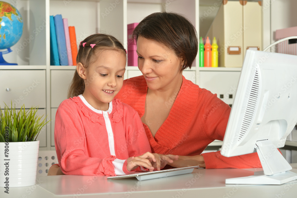Close up porait of mother and daughter using laptop Close up porait of mother and daughter using laptop