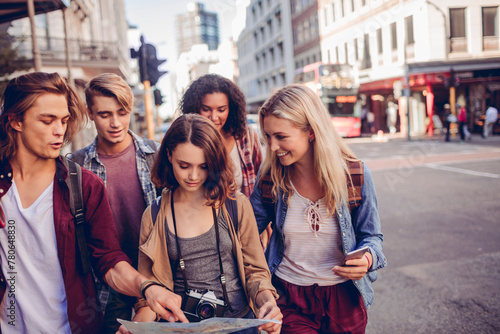 Young tourist people exploring the city with a map photo