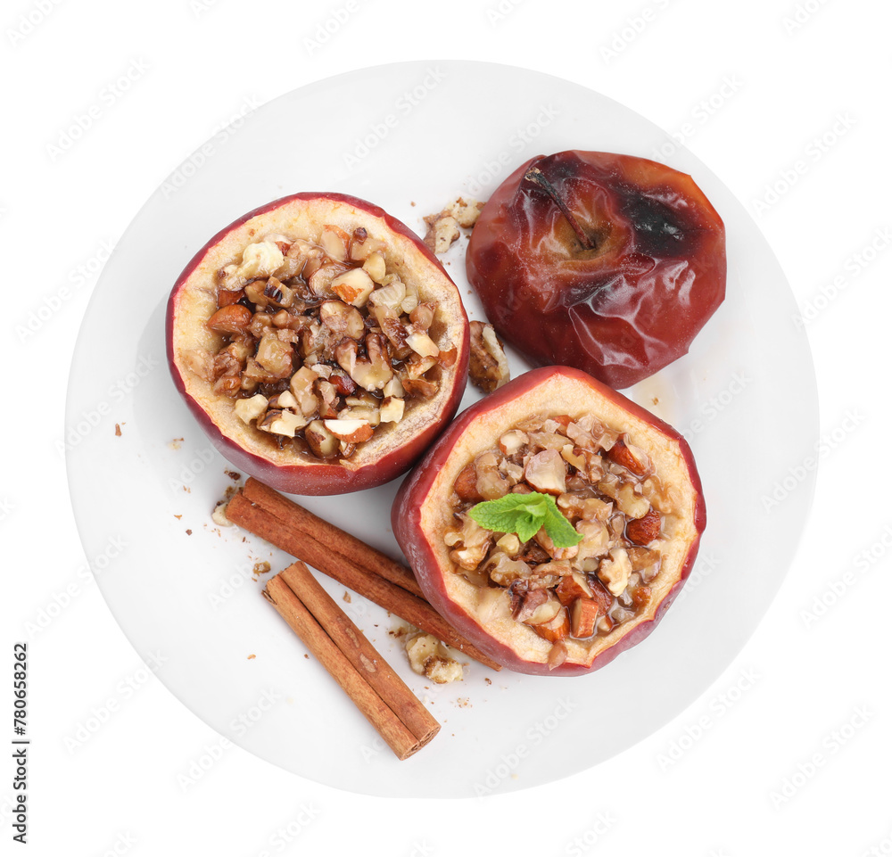 Tasty baked apples with nuts, honey, cinnamon sticks, top view Tasty baked apples with nuts, honey, cinnamon sticks, top view