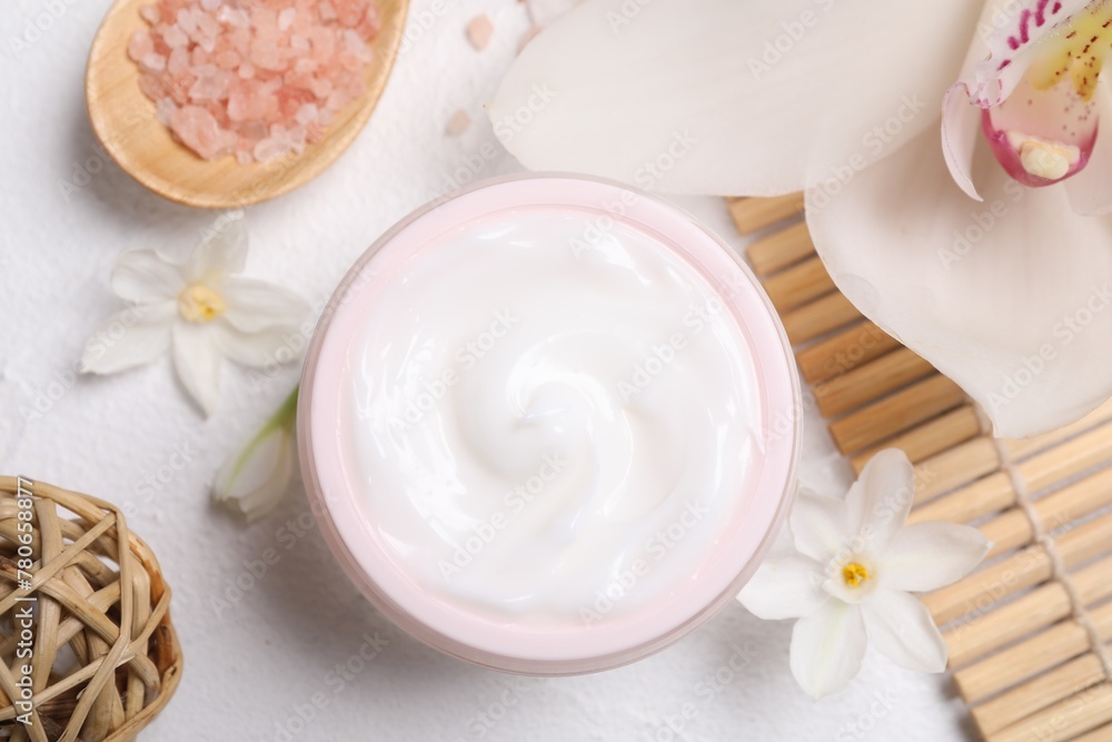 Beautiful spa composition with cosmetic products and flowers on white table, flat lay Beautiful spa composition with cosmetic products and flowers on white table, flat lay