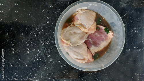 Raw chicken meat marinating on the table