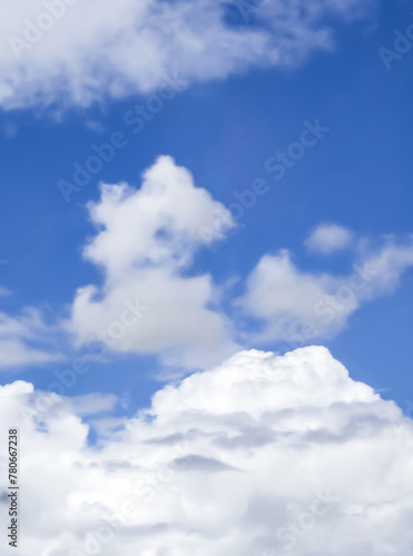  Abstract background of soft fluffy clouds in a bright blue sky.