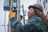 Female electrician installing and repairing wires