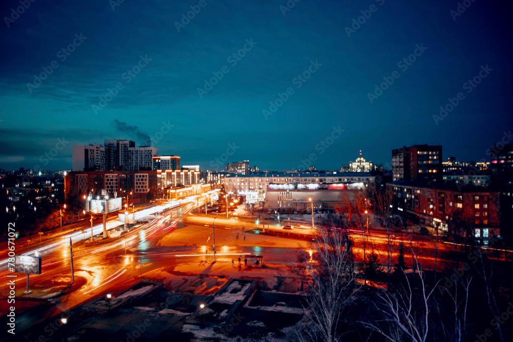  Urban Lights : A bustling urban landscape at dusk, where the fading daylight merges with the electric blurred buzz of streetlights and cars