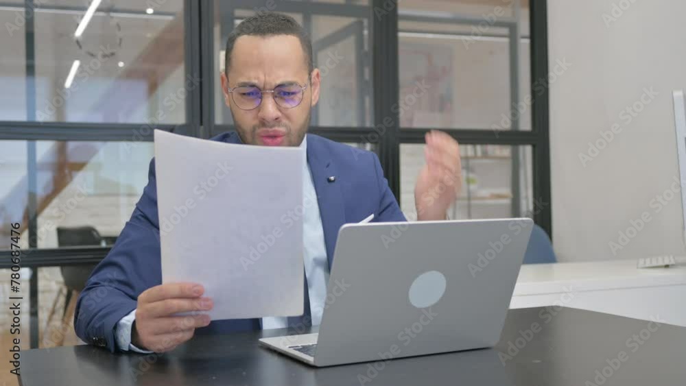 Upset Man in Suit Working on Documents and Laptop, Loss Upset Man in Suit Working on Documents and Laptop, Loss