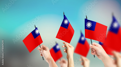 Fototapeta Naklejka Na Ścianę i Meble -  A group of people are holding small flags of Taiwan in their hands.