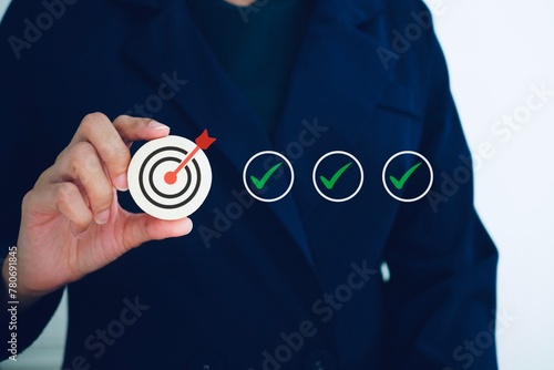 Business strategy planning and planning concepts, setting goals, evaluating business process controls. and a wooden block with a target icon with the correct checklist.