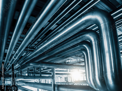 Network of gleaming steel pipes runs with precision, illustrating vital veins of industrial facility. Abstract pipe industry background